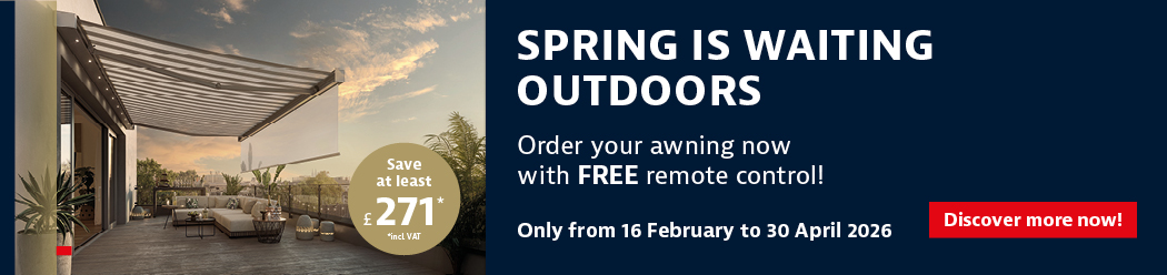 A modern outdoor space featuring an awning, with a sunset sky and greenery in the background.