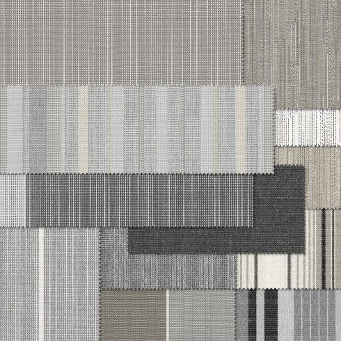 Textiles in various shades of grey with different textures and patterns.