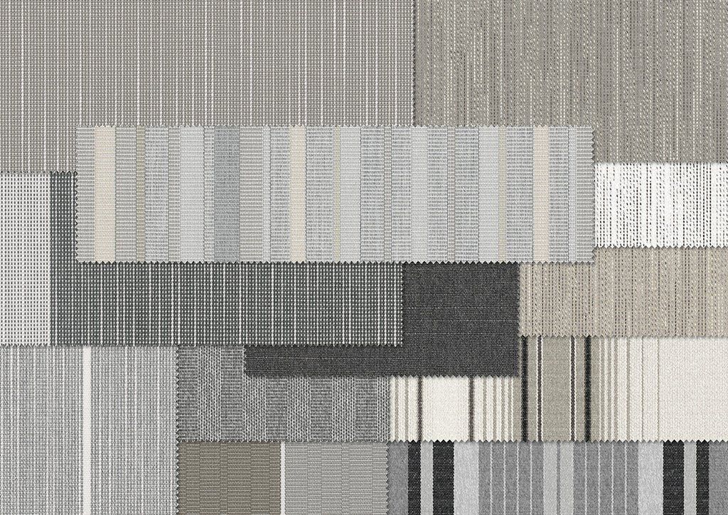 Verschillende stoffen in grijstinten met een duidelijke textuur en geometrische vormen.