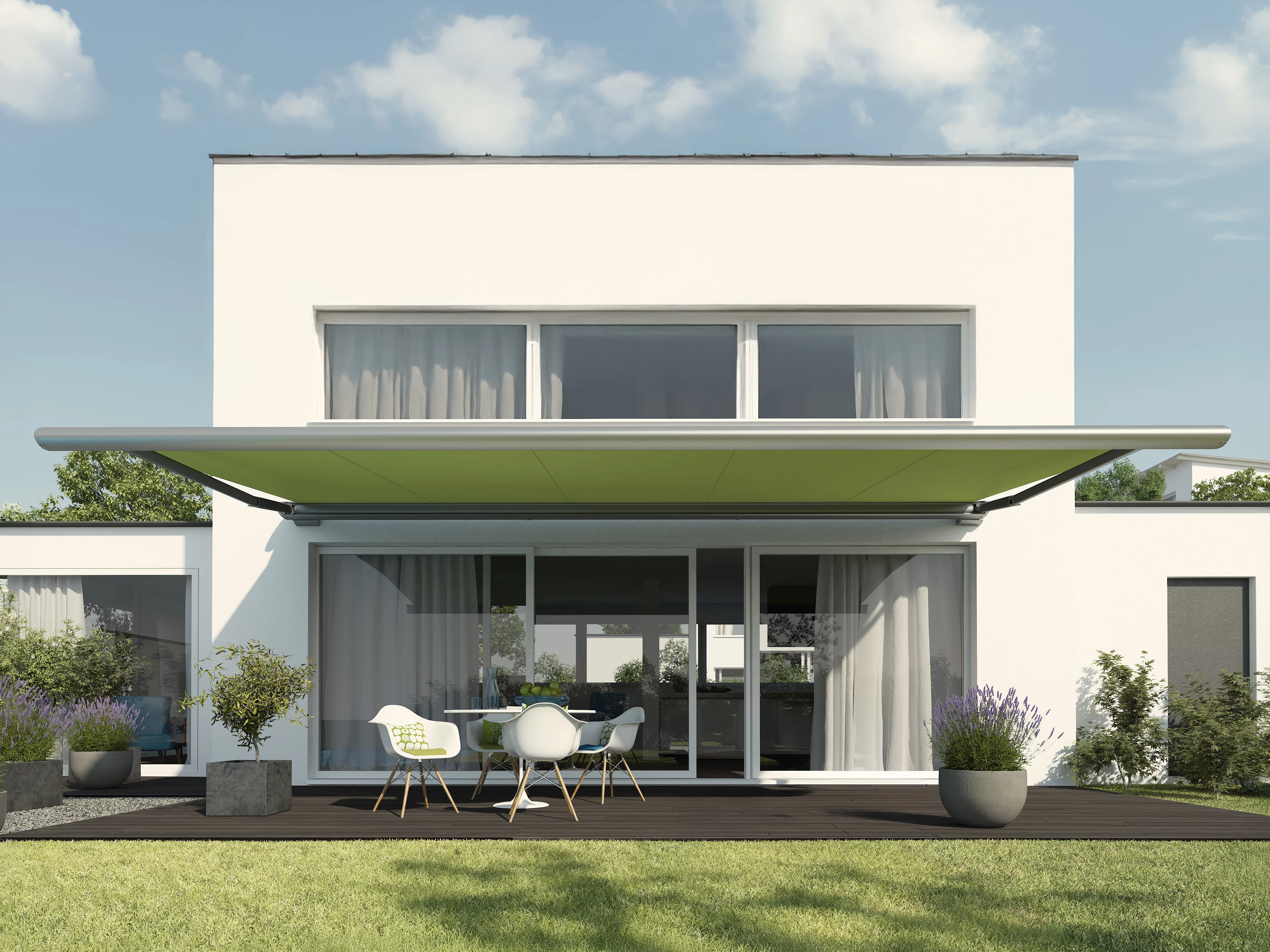 A modern house with a flat roof, featuring a green awning and a spacious outdoor area.