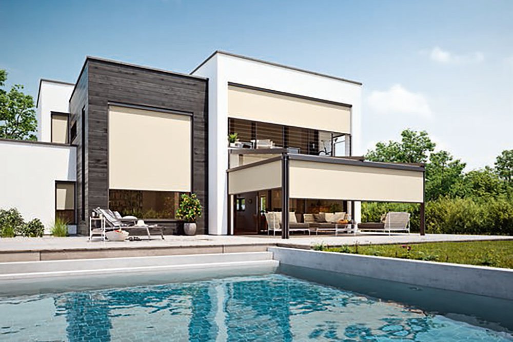 Modern house with shading structures, pool in the foreground, and clear blue sky.