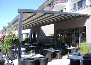 représentation d'une terrasse avec une couverture en toile, des tables et chaises noires à l'extérieur. 